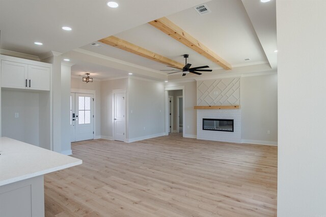 240 Michelle Dr, Beebe, AR 72012 - unfurnished living room featuring crown molding, visible vents, and light wood-style floors