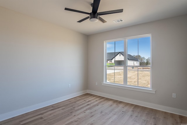 240 Michelle Dr, Beebe, AR 72012 - empty room with wood finished floors, baseboards, a ceiling fan, and visible vents