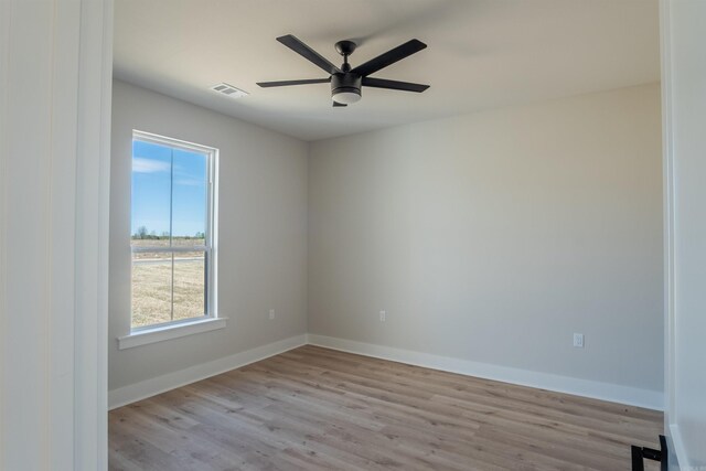 240 Michelle Dr, Beebe, AR 72012 - unfurnished room featuring wood finished floors, baseboards, a ceiling fan, and visible vents
