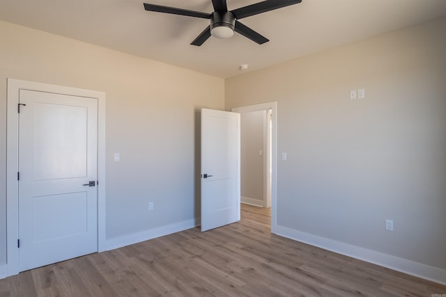 240 Michelle Dr, Beebe, AR 72012 - unfurnished bedroom featuring baseboards, a ceiling fan, and wood finished floors