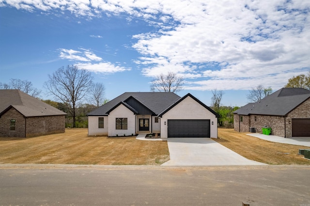 240 Michelle Dr, Beebe, AR 72012 - modern farmhouse style home with a front yard, driveway, stucco siding, and an attached garage