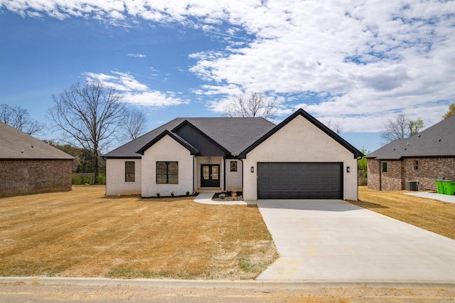 240 Michelle Dr, Beebe, AR 72012 - modern farmhouse featuring central AC unit, a garage, brick siding, a front lawn, and driveway