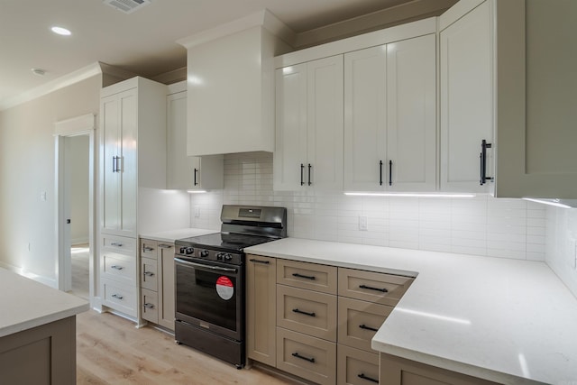 240 Michelle Dr, Beebe, AR 72012 - kitchen featuring visible vents, light countertops, stainless steel electric stove, light wood finished floors, and backsplash