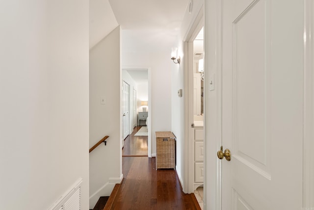 5 Huntington Rd, Little Rock, AR 72227 - corridor featuring baseboards, dark wood-style flooring, and an upstairs landing