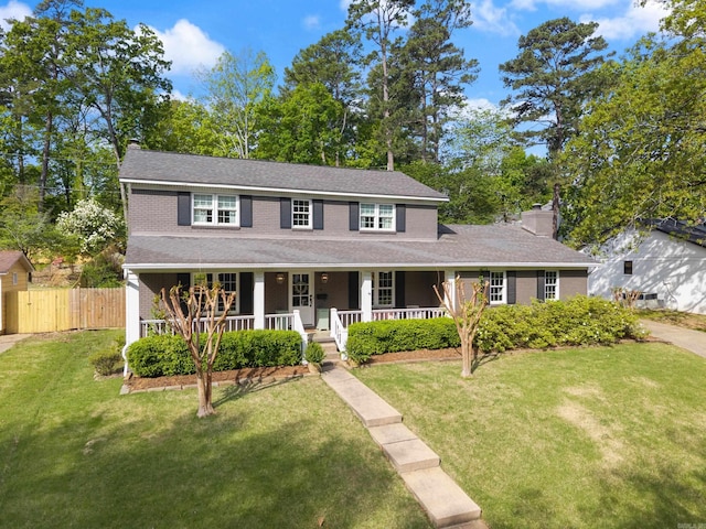 5 Huntington Rd, Little Rock, AR 72227 - view of front of home with a porch, a front lawn, fence, and a chimney