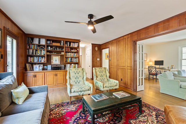 5 Huntington Rd, Little Rock, AR 72227 - living room featuring ceiling fan, wood walls, and light wood-style floors