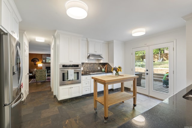 5 Huntington Rd, Little Rock, AR 72227 - kitchen featuring under cabinet range hood, french doors, stainless steel appliances, and stone tile floors