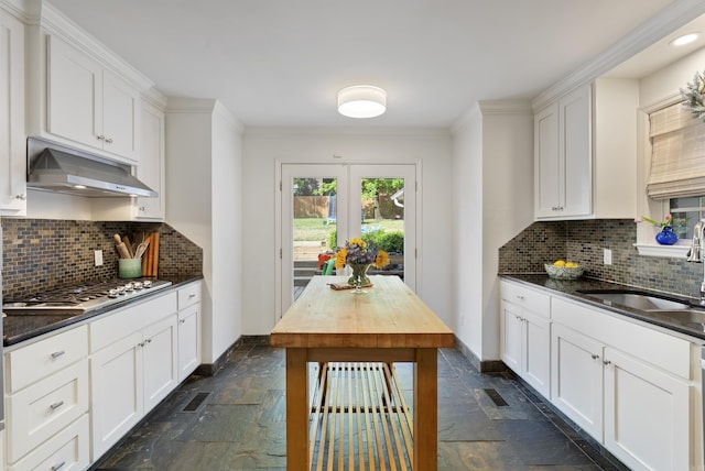 5 Huntington Rd, Little Rock, AR 72227 - kitchen featuring stainless steel appliances, stone tile flooring, a sink, baseboards, and under cabinet range hood