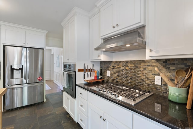 5 Huntington Rd, Little Rock, AR 72227 - kitchen with appliances with stainless steel finishes, white cabinetry, backsplash, under cabinet range hood, and stone finish floor