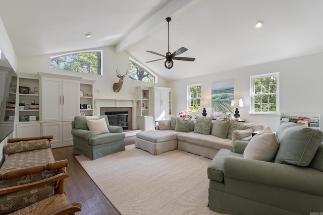 5 Huntington Rd, Little Rock, AR 72227 - living area featuring a ceiling fan, a healthy amount of sunlight, a glass covered fireplace, and dark wood-style floors