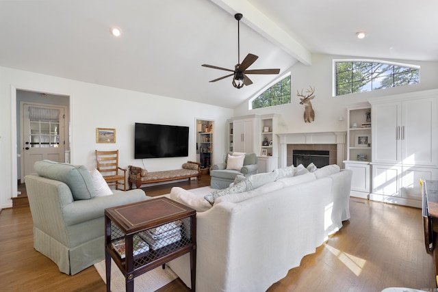 5 Huntington Rd, Little Rock, AR 72227 - living room featuring high vaulted ceiling, wood finished floors, ceiling fan, beamed ceiling, and a tiled fireplace