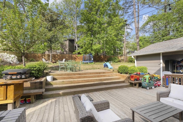 5 Huntington Rd, Little Rock, AR 72227 - wooden deck with area for grilling, a fenced backyard, outdoor dining space, and a trampoline