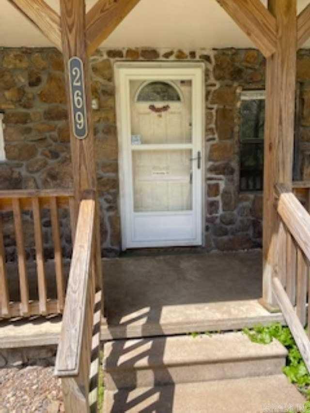 doorway to property with stone siding