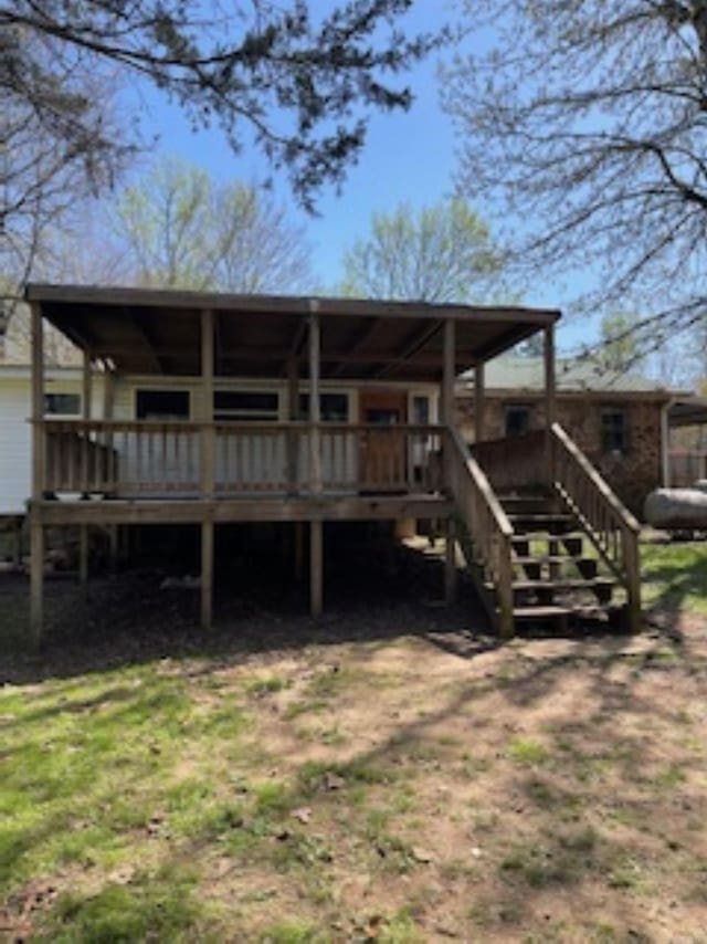rear view of house featuring a deck and stairway