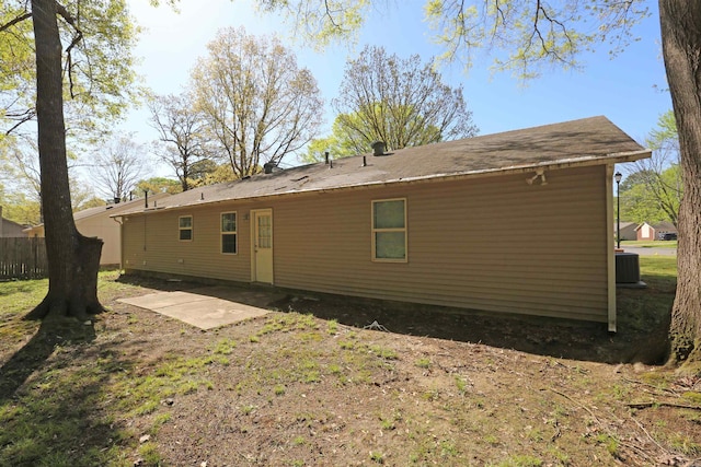 rear view of property featuring a patio area, fence, and central air condition unit