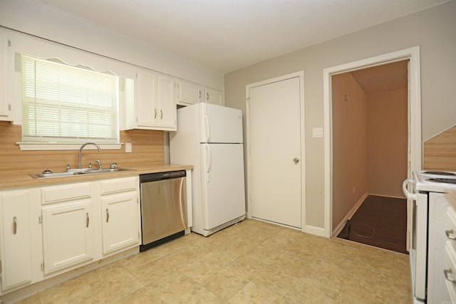 kitchen with white cabinets, white appliances, light countertops, and a sink