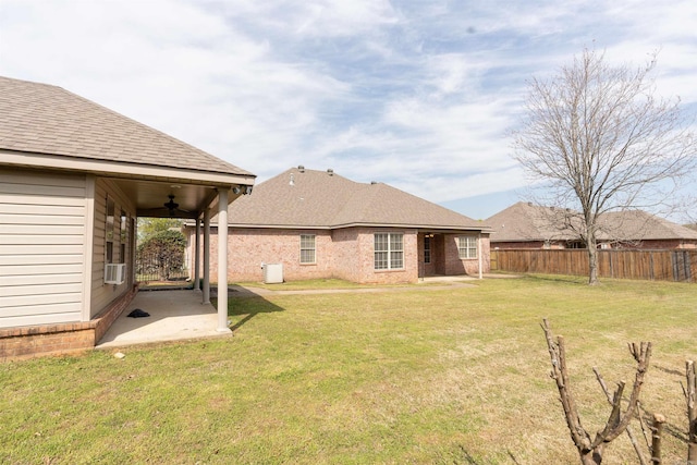 408 Crain Dr, Searcy, AR 72143 - rear view of house featuring fence, a patio area, a ceiling fan, and a lawn