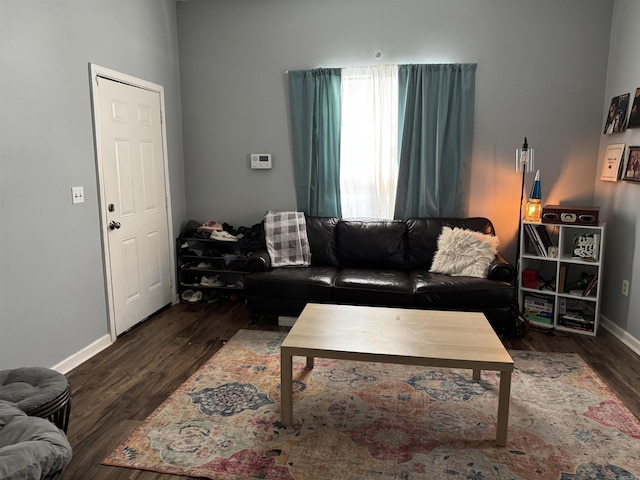 living area with baseboards and wood finished floors