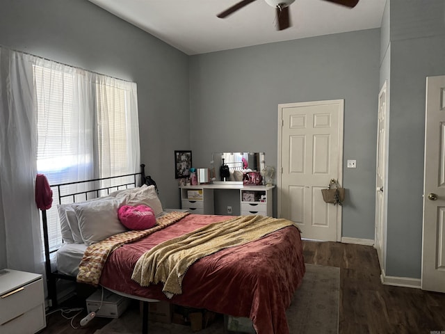 bedroom with baseboards, a ceiling fan, and wood finished floors