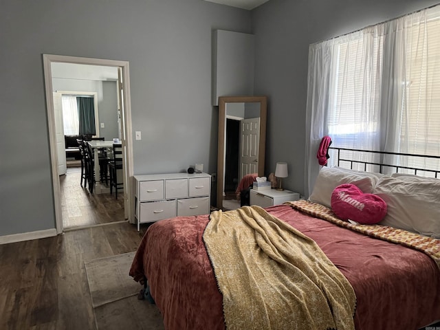 bedroom with dark wood-type flooring