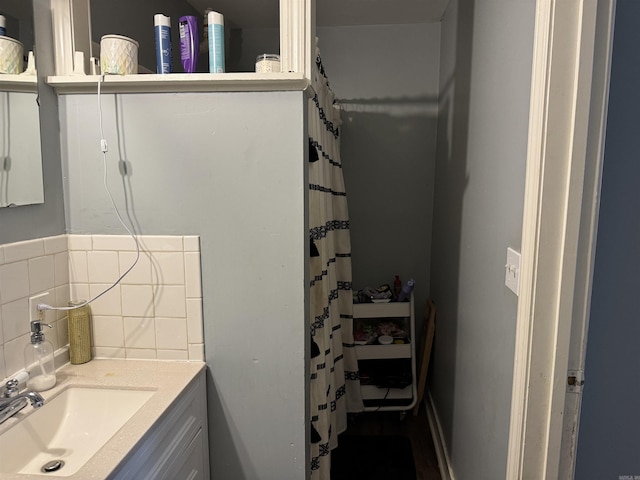 bathroom featuring tasteful backsplash, vanity, and a shower with curtain