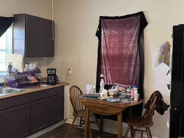 dining space featuring baseboards and dark wood finished floors