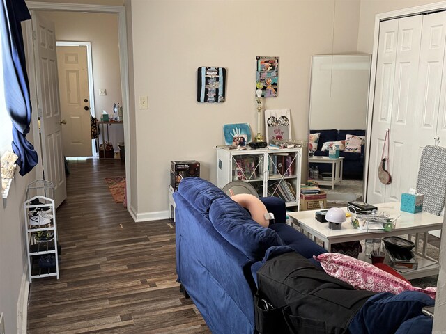 living room featuring baseboards and wood finished floors