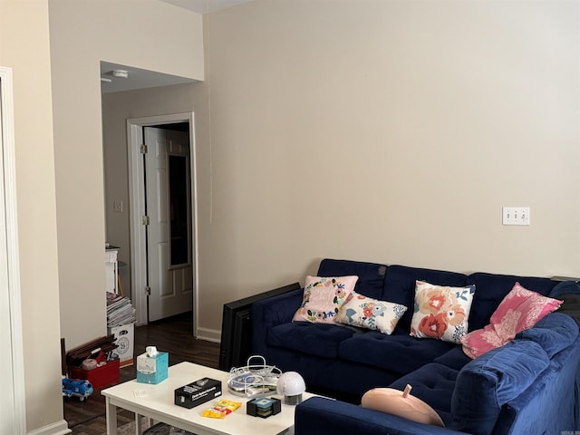 living room featuring baseboards and dark wood-style floors