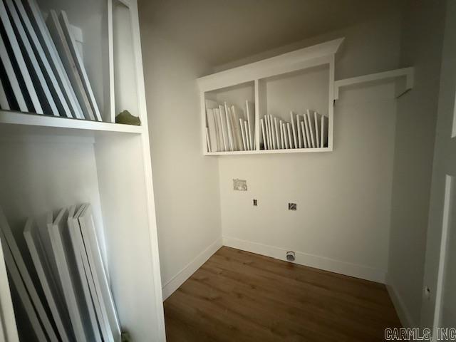 laundry room featuring baseboards and wood finished floors