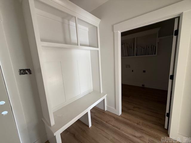 mudroom with wood finished floors and baseboards