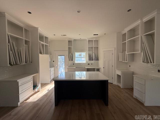 kitchen with wood finished floors, backsplash, open shelves, and a kitchen island