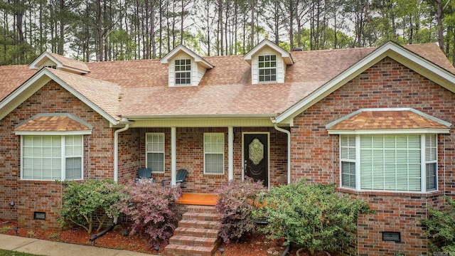 7 Ridge Creek Pt, Arkadelphia, AR 71923 - view of front of house with brick siding, covered porch, crawl space, and roof with shingles
