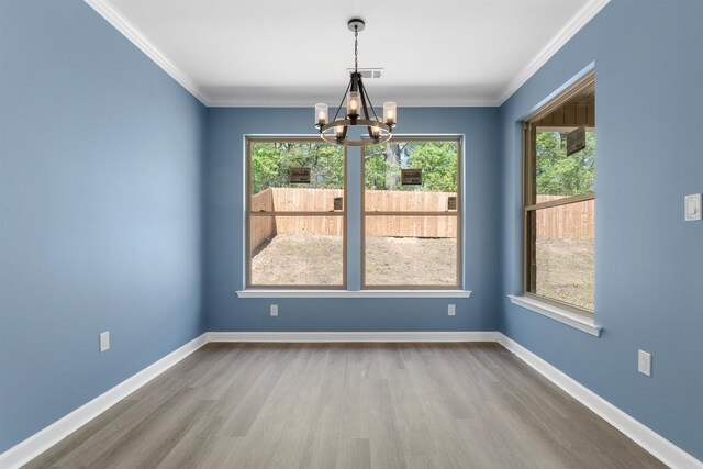 8010 Kanis Oaks Dr, Little Rock, AR 72204 - spare room with an inviting chandelier, ornamental molding, visible vents, wood finished floors, and baseboards
