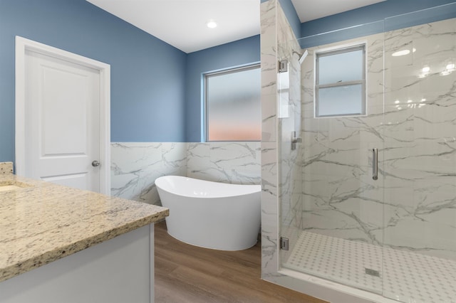 8010 Kanis Oaks Dr, Little Rock, AR 72204 - full bath with vanity, wood finished floors, tile walls, a freestanding bath, and a marble finish shower