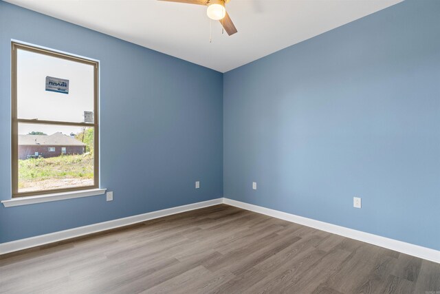 8010 Kanis Oaks Dr, Little Rock, AR 72204 - empty room with wood finished floors, baseboards, and a ceiling fan