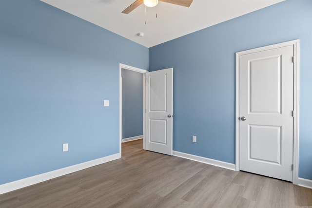 8010 Kanis Oaks Dr, Little Rock, AR 72204 - unfurnished bedroom with wood finished floors, baseboards, and a ceiling fan