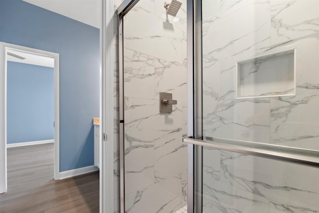 8010 Kanis Oaks Dr, Little Rock, AR 72204 - bathroom with wood finished floors, a marble finish shower, and baseboards