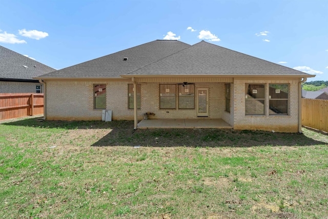 8010 Kanis Oaks Dr, Little Rock, AR 72204 - back of house with ceiling fan, a fenced backyard, a lawn, a patio, and brick siding