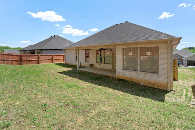 8010 Kanis Oaks Dr, Little Rock, AR 72204 - rear view of house featuring a yard, fence, a patio, brick siding, and roof with shingles