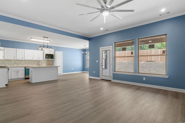 8010 Kanis Oaks Dr, Little Rock, AR 72204 - unfurnished living room featuring dark wood-type flooring, visible vents, ceiling fan with notable chandelier, and ornamental molding