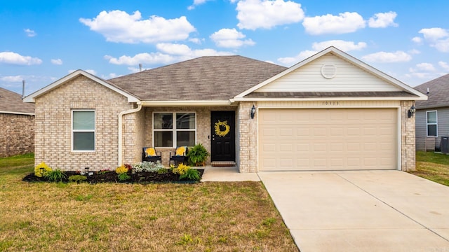 ranch-style home featuring driveway, an attached garage, a shingled roof, and a front lawn