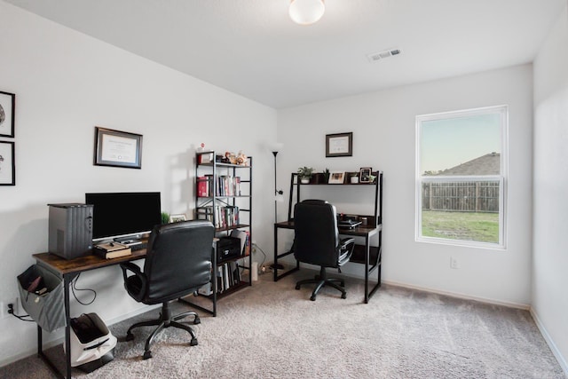 carpeted home office with visible vents and baseboards