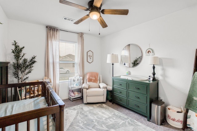 bedroom featuring light carpet, a ceiling fan, and visible vents
