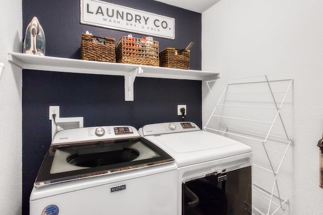 washroom featuring washer and clothes dryer and laundry area
