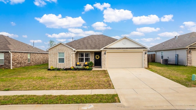 ranch-style home featuring roof with shingles, driveway, a front yard, brick siding, and a garage