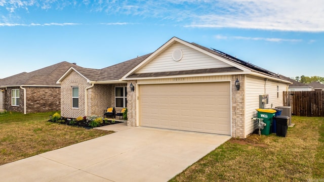single story home with driveway, an attached garage, a front lawn, brick siding, and roof mounted solar panels