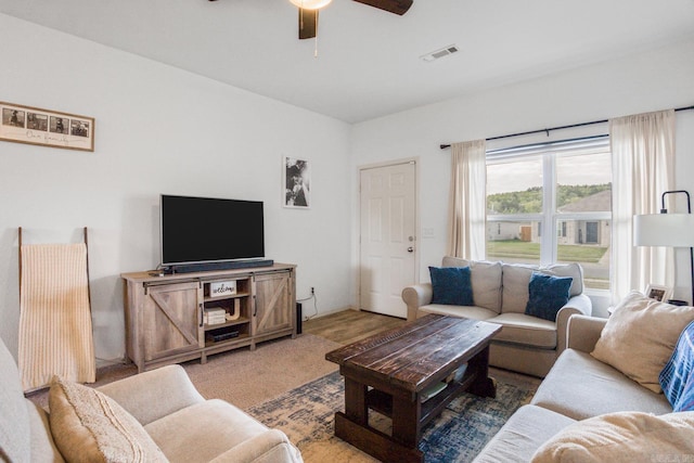 living area with visible vents and a ceiling fan