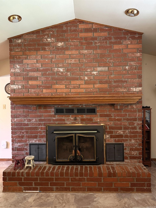 interior details featuring a brick fireplace and visible vents