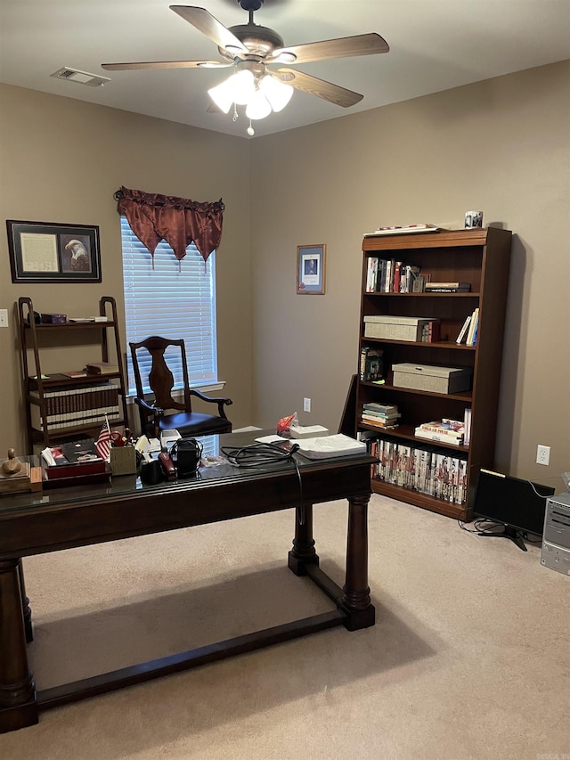 office space with visible vents, ceiling fan, and carpet