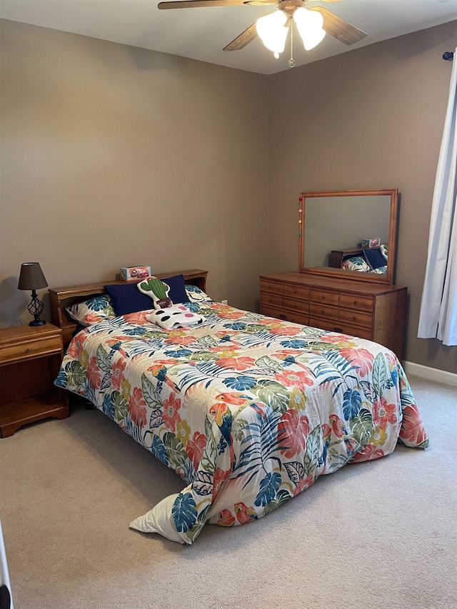 carpeted bedroom with a ceiling fan